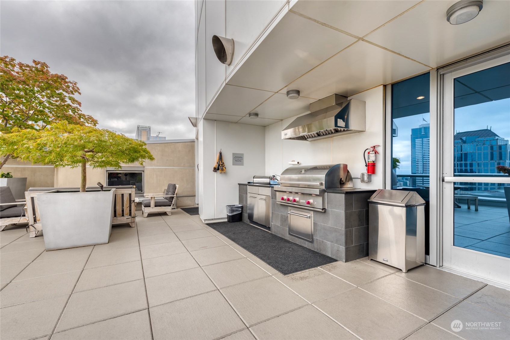 1521 2nd Avenue, Unit 3601 Seattle, WA 98101 - Photo 33 of 39 a kitchen with stainless steel appliances granite countertop a sink and a counter