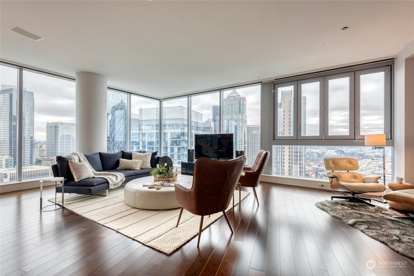 1521 2nd Avenue, Unit 3601 Seattle, WA 98101 - Photo 4 of 39 a living room with furniture and floor to ceiling windows
