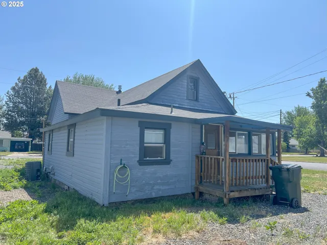 a view of a house with a yard and deck