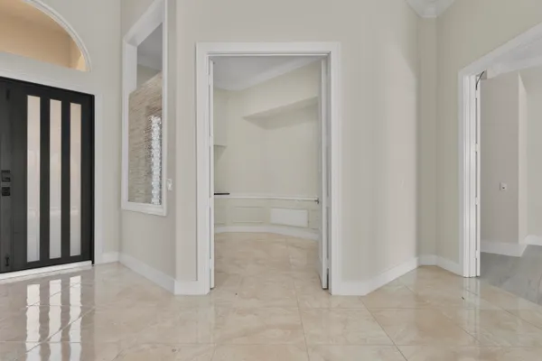 an empty room with closet and a bathroom