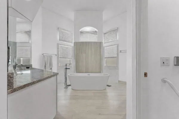 a bathroom with a granite countertop sink a shower and a mirror