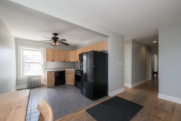 a view of a kitchen with a sink refrigerator and window