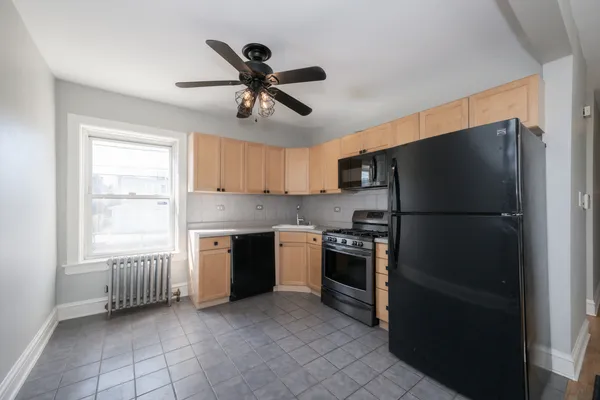 a kitchen with a refrigerator and a sink