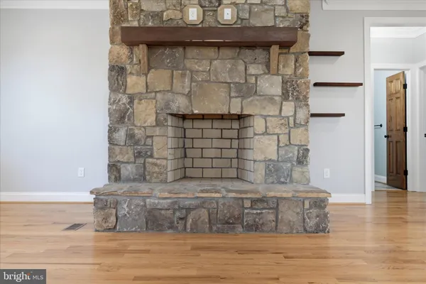 a kitchen that has a lot of cabinets and wooden floor