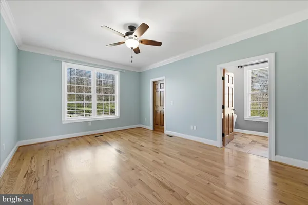 a view of a hallway with wooden floor and entryway
