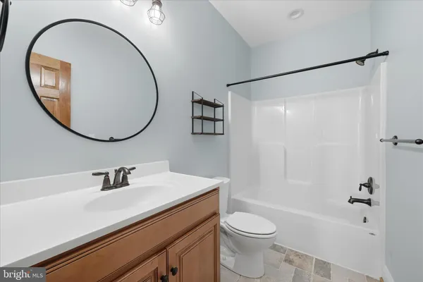 a view of a livingroom with a ceiling fan and window