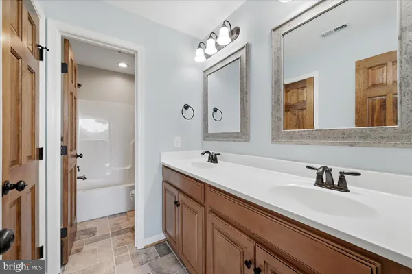 a view of a house with wooden fence