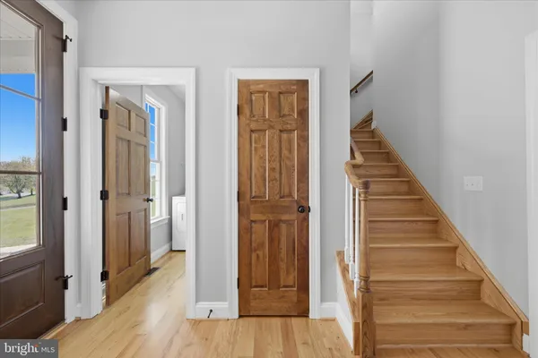 a front view of a house with a garden and plants