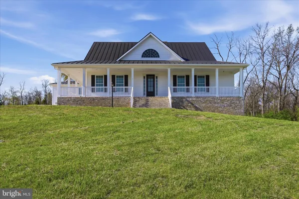 a view of staircase with lots of frames on wall and a window