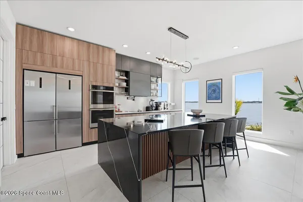 a kitchen with stainless steel appliances kitchen island granite countertop a sink and cabinets