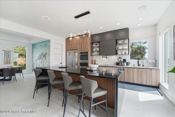 a kitchen with kitchen island granite countertop lots of counter top space and stainless steel appliances