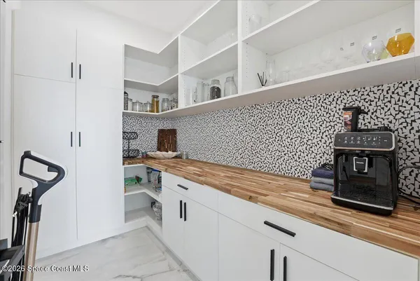a kitchen with stainless steel appliances kitchen island a table and chairs in it