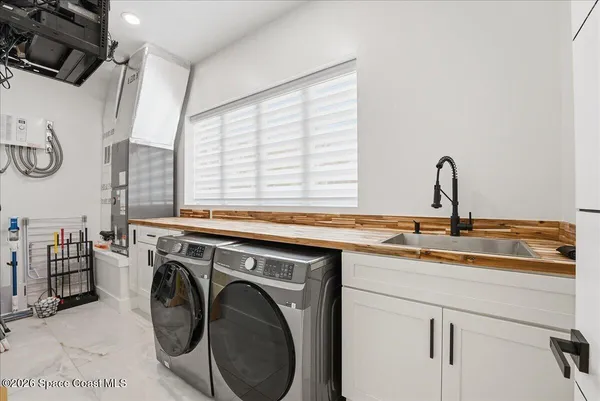 a bathroom with a bathtub sink mirror and toilet