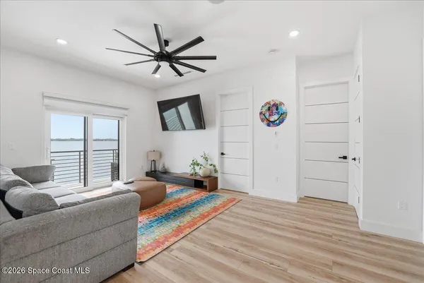 a bedroom with a large bed and a large window