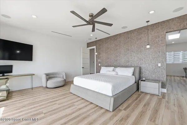 a bathroom with a double vanity sink and mirror with bathtub