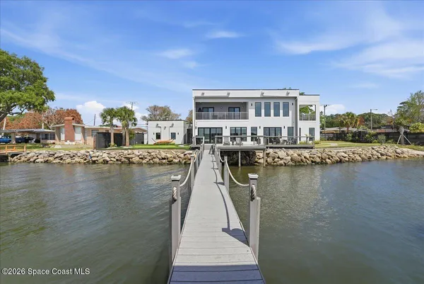 a view of a lake with boats and trees in the background