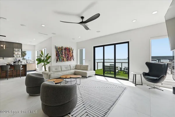 a living room with furniture fireplace and a large window