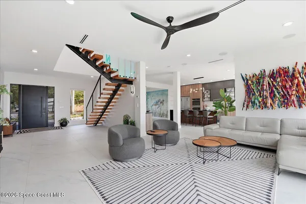 a kitchen with stainless steel appliances a table chairs refrigerator and microwave