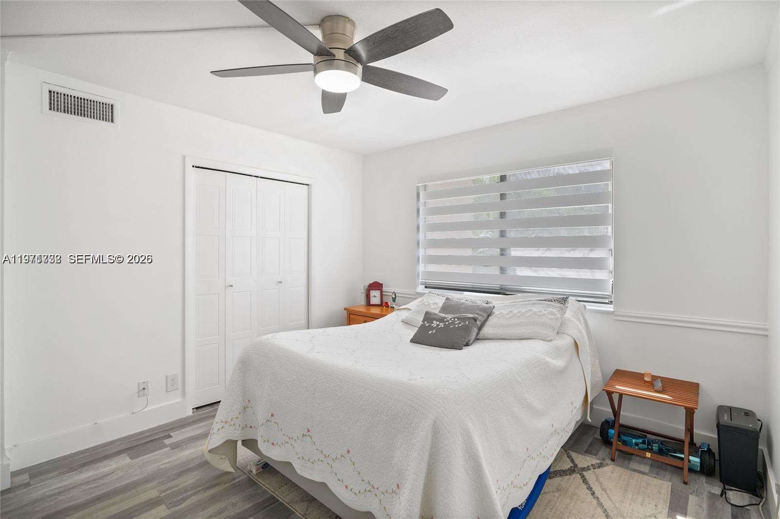 380 Racquet Club Road, Unit 204 Weston, FL 33326 - Photo 13 of 15 a bedroom with a bed and a chandelier