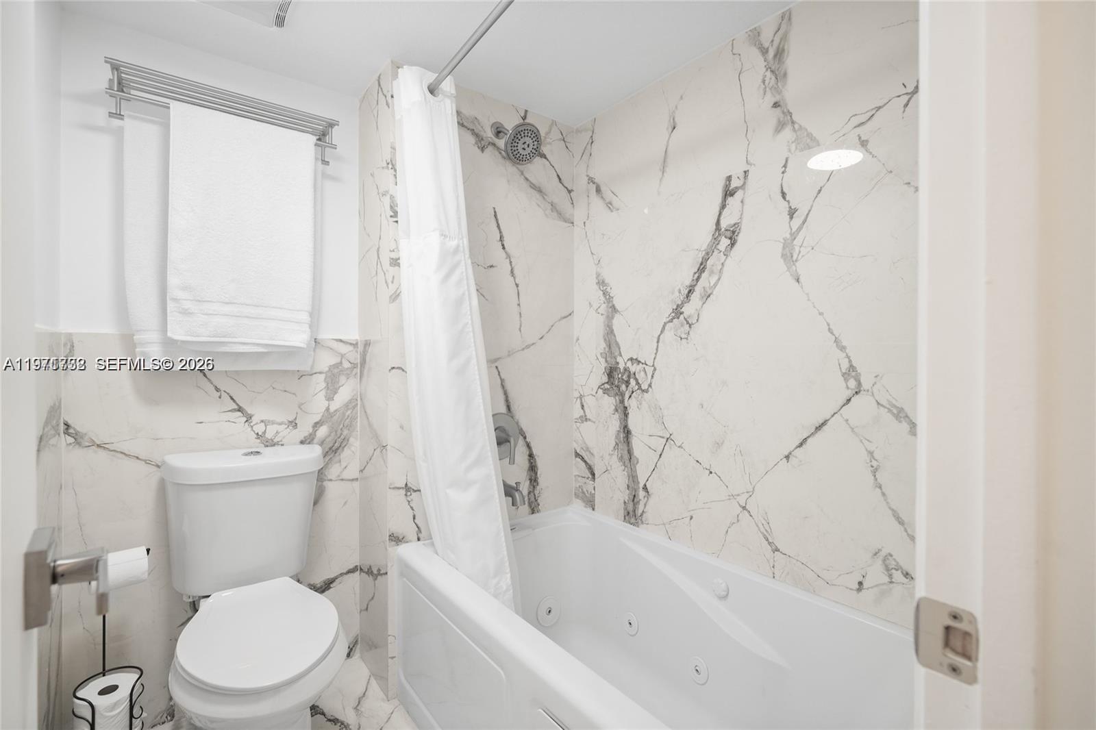 380 Racquet Club Road, Unit 204 Weston, FL 33326 - Photo 14 of 15 a white toilet sitting next to a bath tub