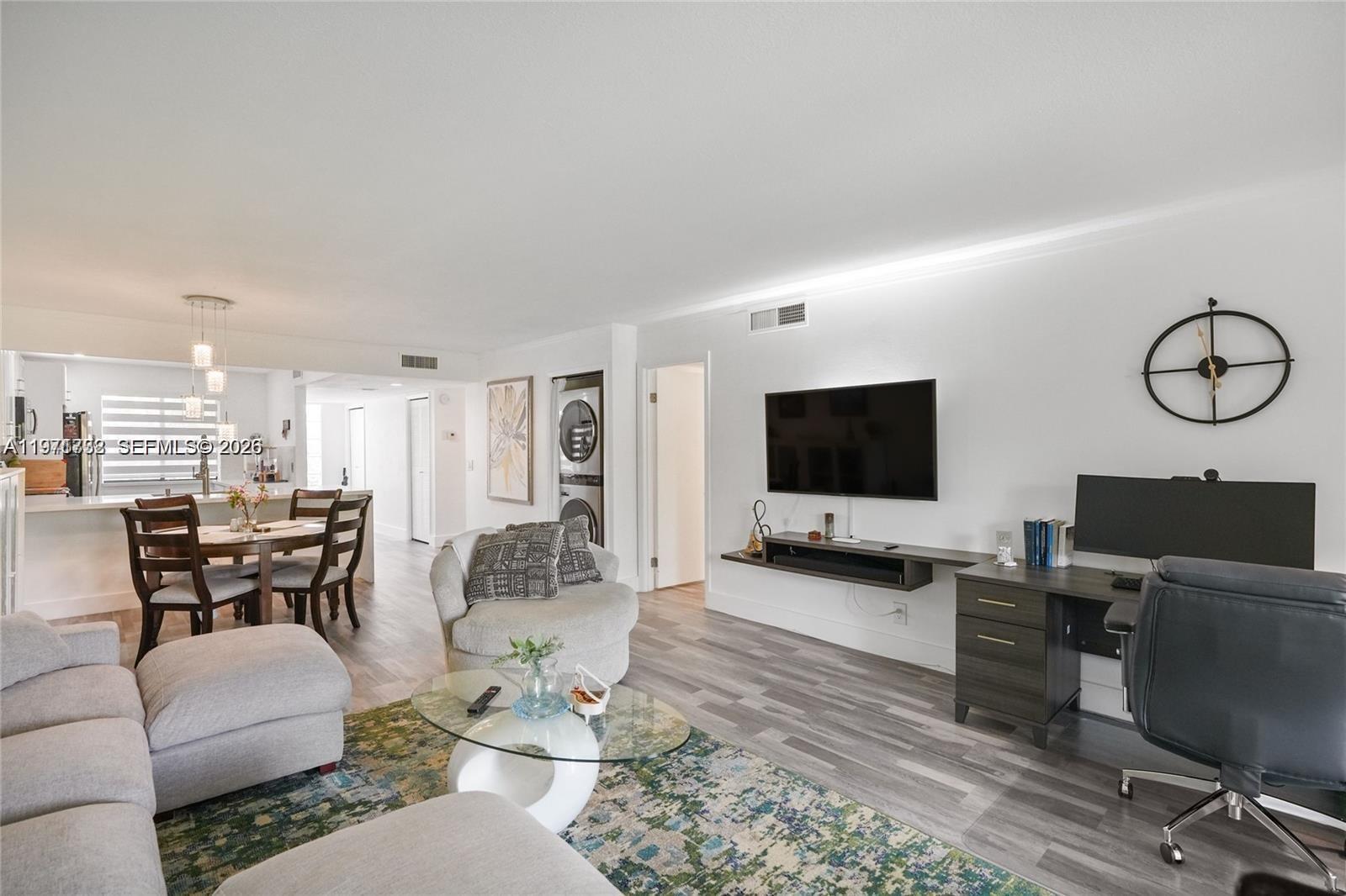 380 Racquet Club Road, Unit 204 Weston, FL 33326 - Photo 7 of 15 a living room with furniture and a flat screen tv