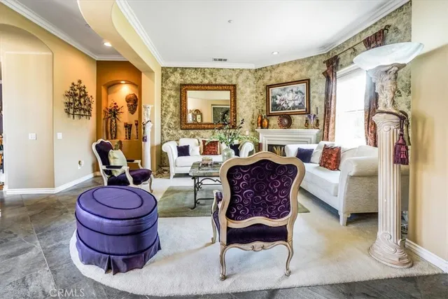 a living room with furniture a lamp and large window