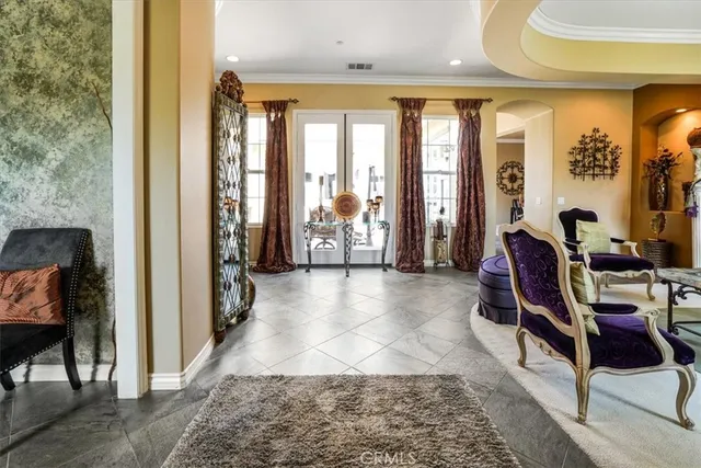 a living room with furniture a flat screen tv and a large window