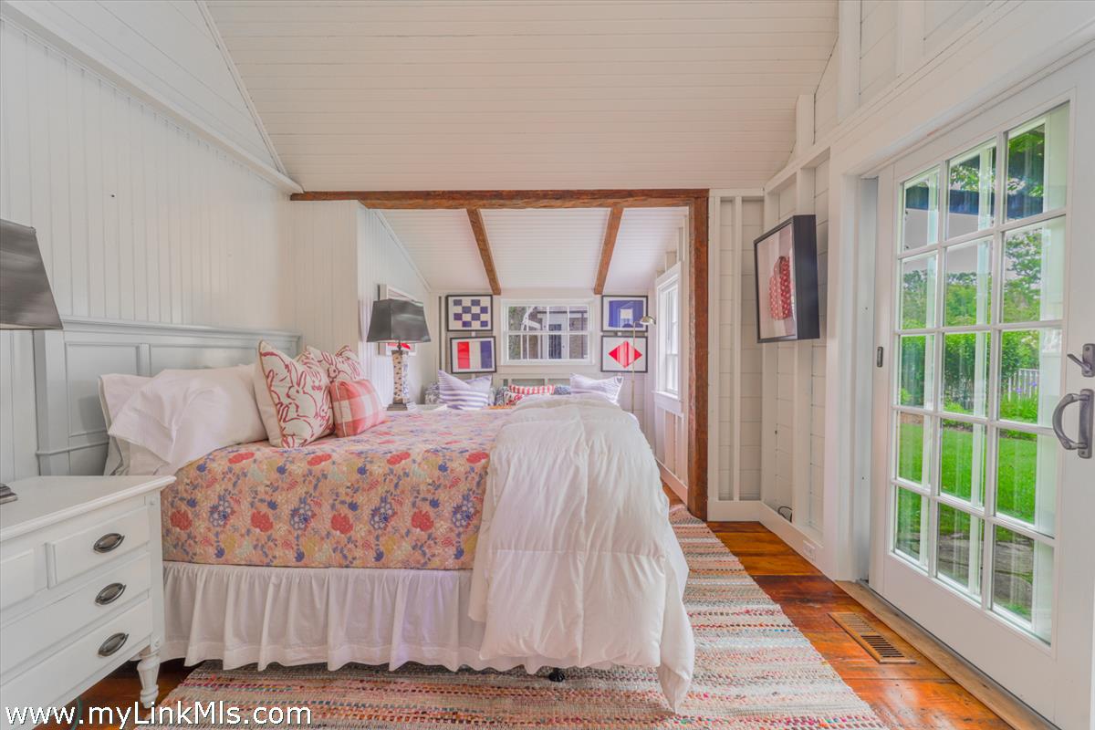 14 & 16 Coffin Street Nantucket, MA 02554 - Photo 41 of 50 a bedroom with a large bed and a large window