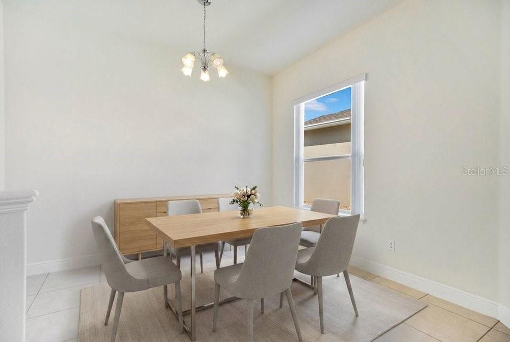 208 Lamonte Pointe Circle DeBary, FL 32713 - Photo 11 of 47 a view of a dining room with furniture and chandelier