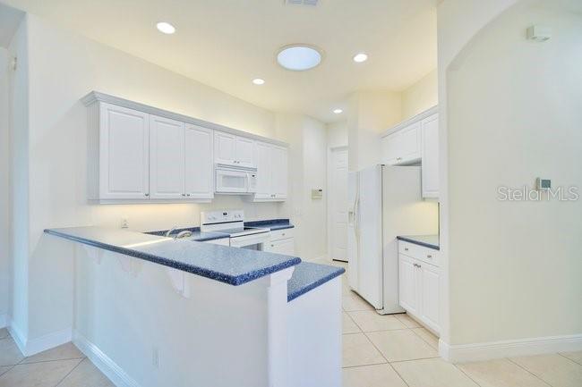 208 Lamonte Pointe Circle DeBary, FL 32713 - Photo 14 of 47 a kitchen with stainless steel appliances granite countertop a refrigerator and a stove