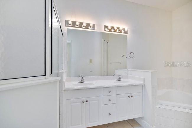 208 Lamonte Pointe Circle DeBary, FL 32713 - Photo 22 of 47 a bathroom with a double vanity sink and mirror