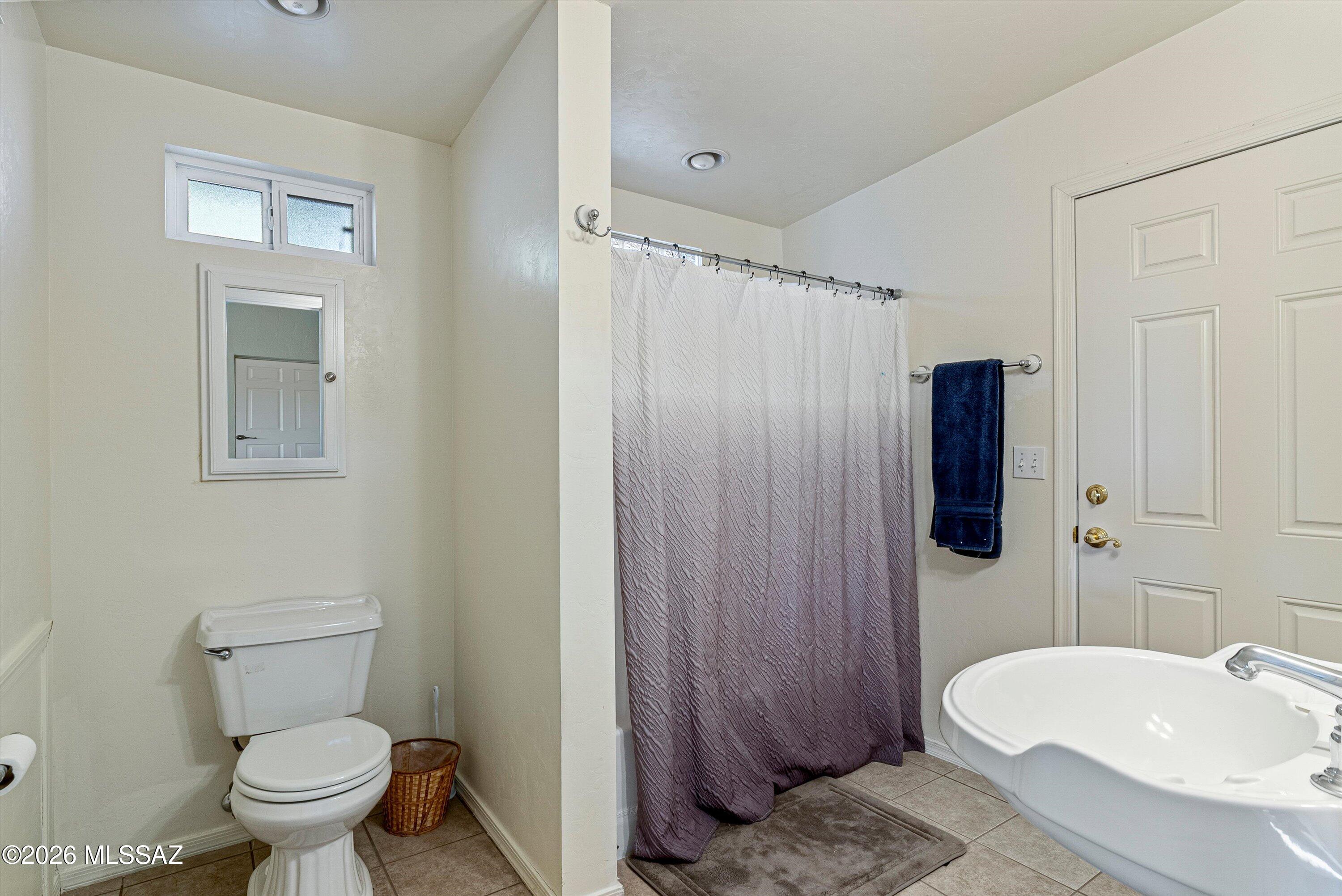 2107 East Lind Road Tucson, AZ 85719 - Photo 40 of 43 a bathroom with a sink toilet and shower