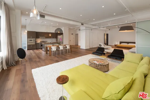 a living room with dining table furniture and a chandelier