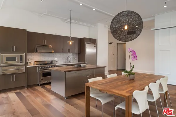 a kitchen with a table chairs stove and microwave