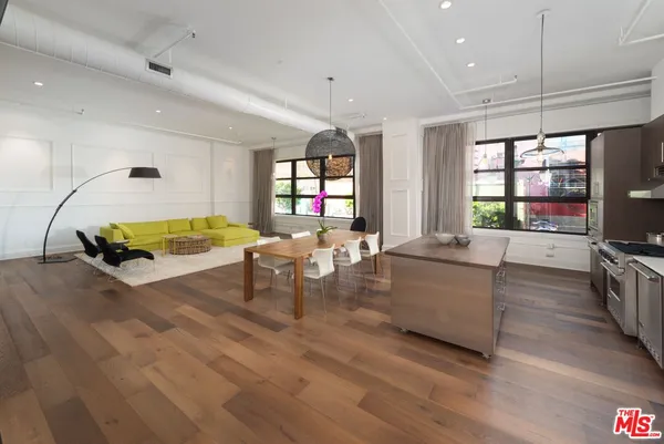 a living room with furniture a flat screen tv and a large window