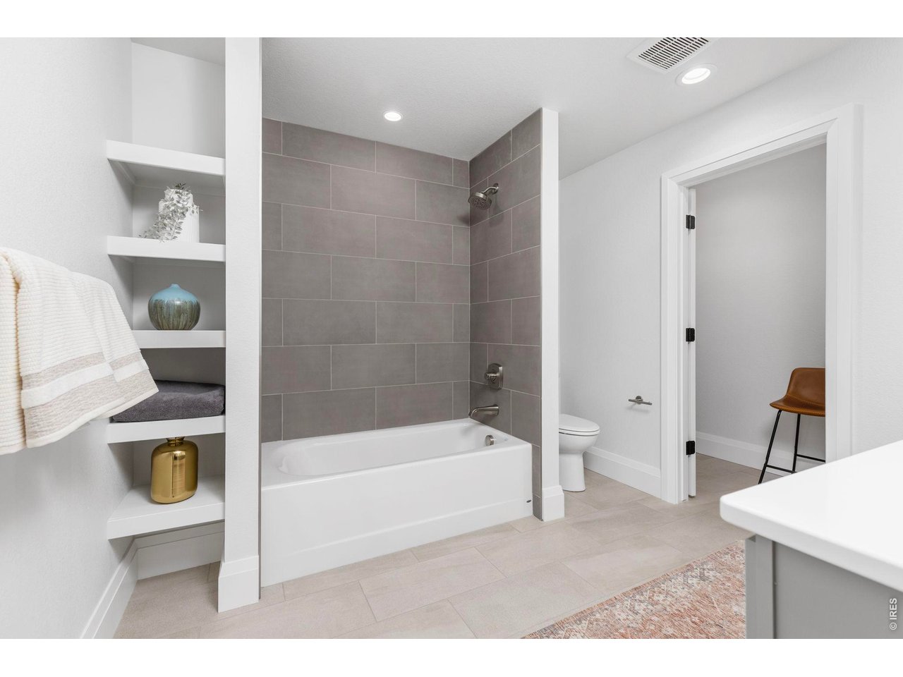5700 West 2nd Street Road Greeley, CO 80634 - Photo 30 of 40 Among the highlights in the upstairs guest bath is a shower/tub with full-height tile surround, storage shelving and a big walk-in closet