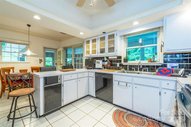 a kitchen with stainless steel appliances kitchen island granite countertop a stove a sink and a microwave
