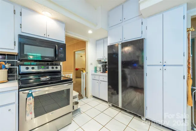 a kitchen with a refrigerator stove and microwave