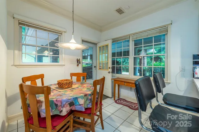 a dining room with furniture a rug and a large window