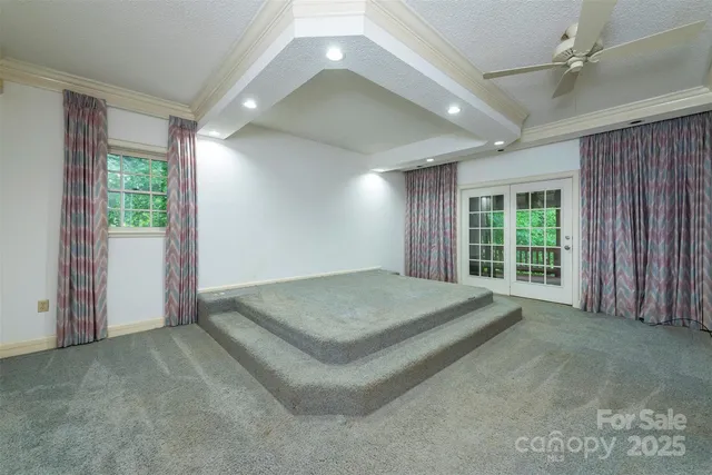 a spacious bedroom with a large bed and large windows