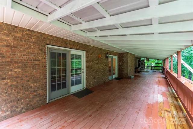 a view of a porch with wooden floor and roof