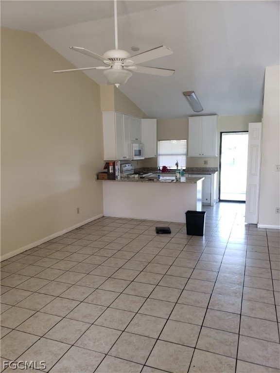 7491 Love Road Fort Myers, FL 33967 - Photo 3 of 5 a kitchen with kitchen island cabinets and window