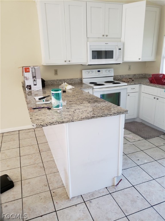 7491 Love Road Fort Myers, FL 33967 - Photo 5 of 5 a kitchen with a sink a stove top oven and white cabinets