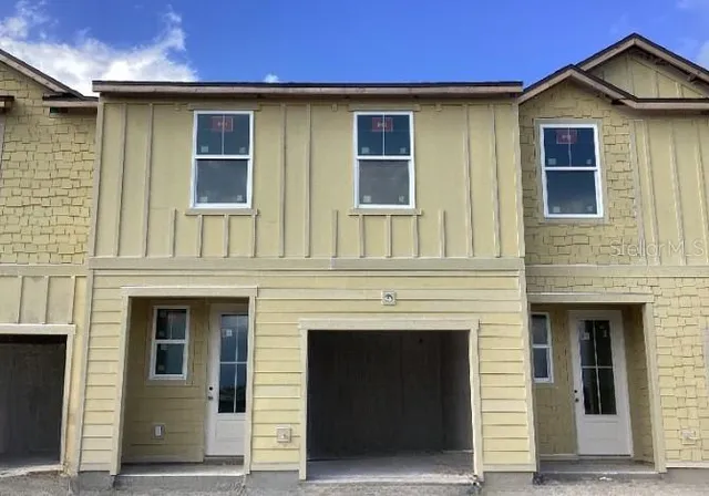 a front view of a house with a garage