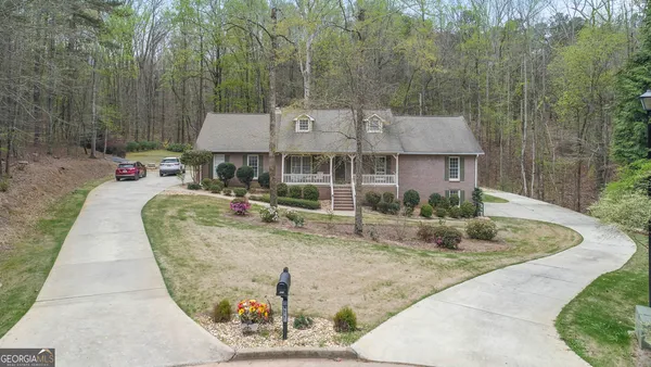 an aerial view of a house with garden and trees