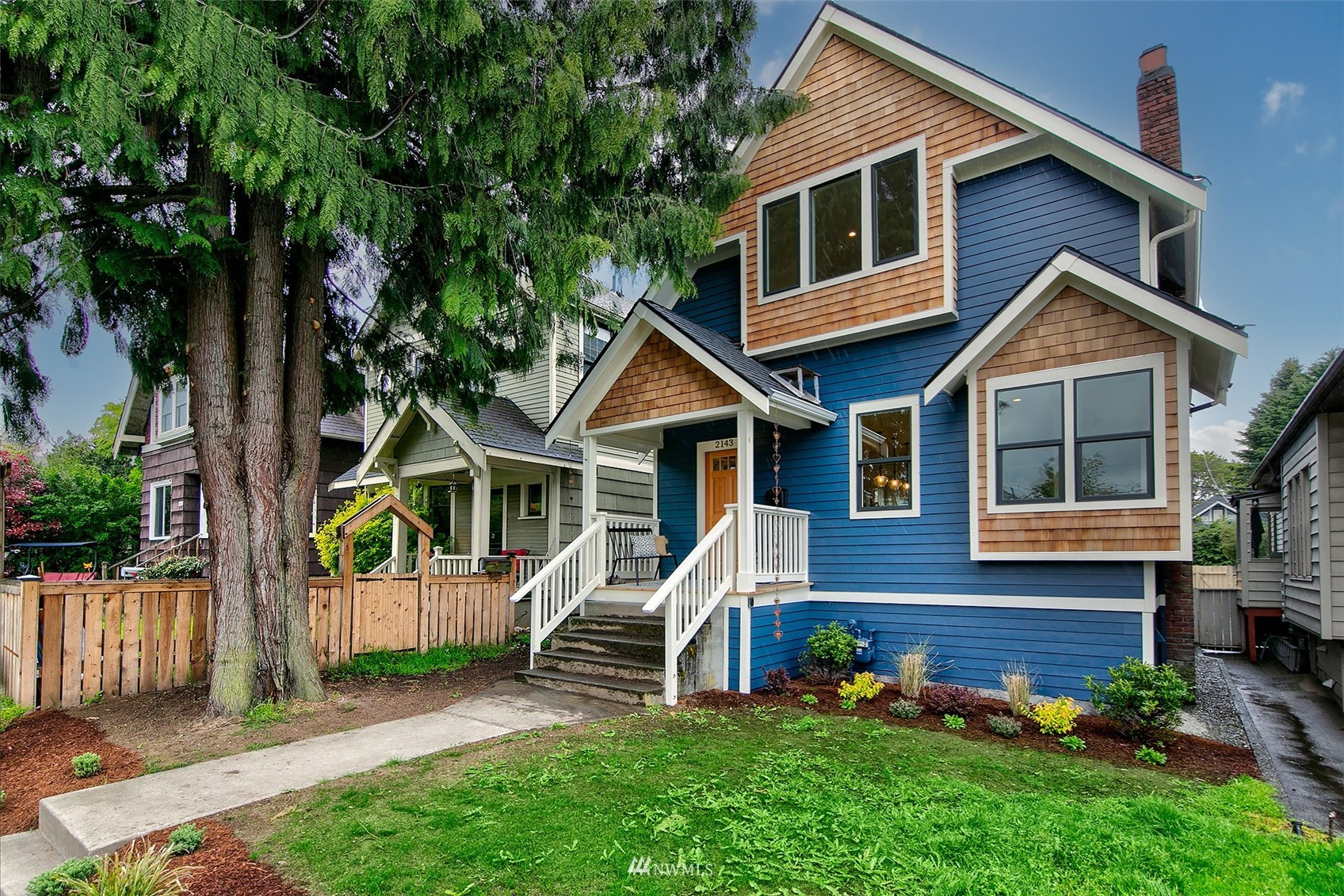 2143 6th Avenue West Seattle, WA 98119 - Photo 2 of 31 a view of a house with a yard and wooden fence