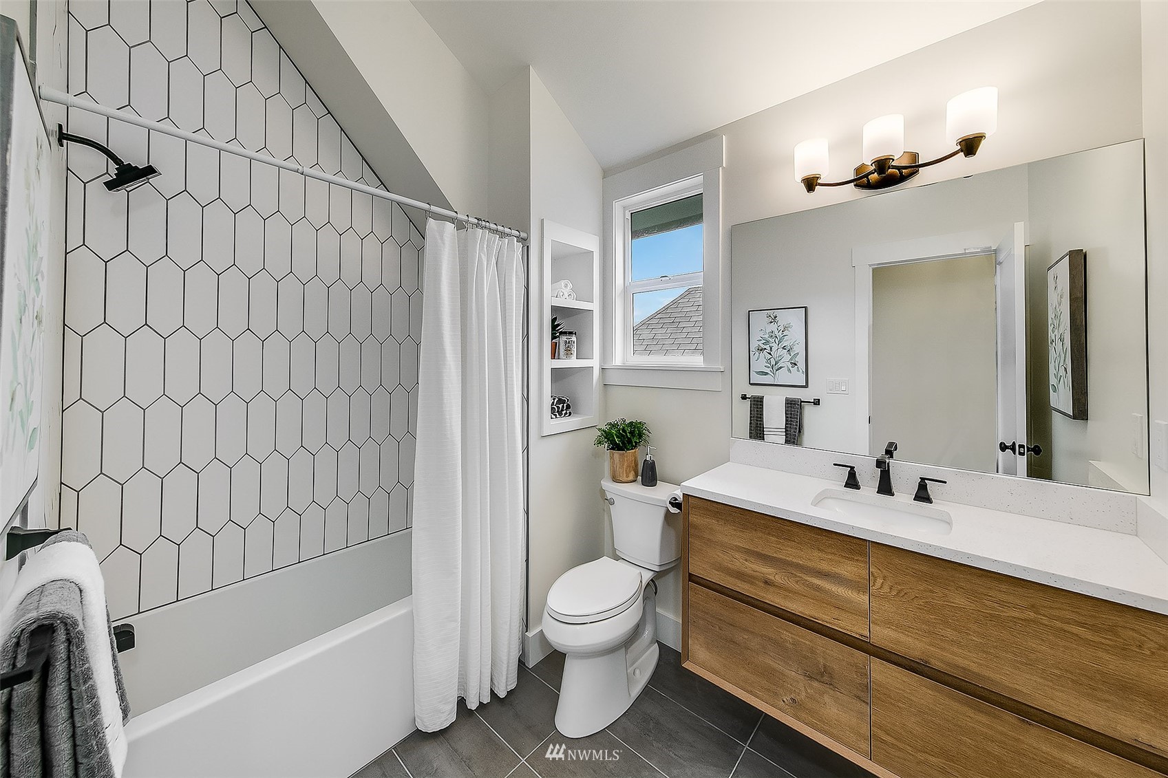 2143 6th Avenue West Seattle, WA 98119 - Photo 21 of 31 a bathroom with a granite countertop sink toilet a mirror and shower