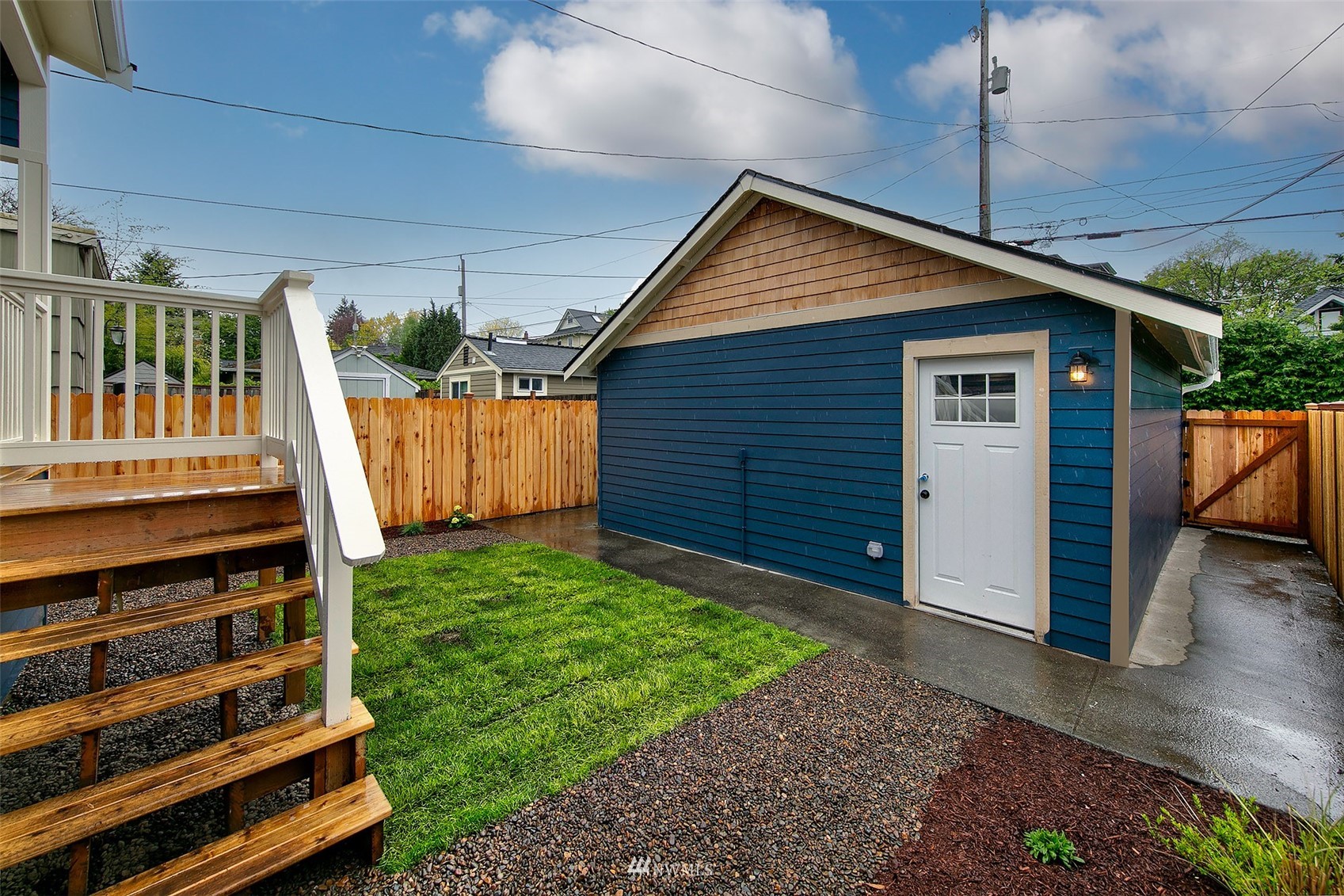 2143 6th Avenue West Seattle, WA 98119 - Photo 30 of 31 a backyard of a house with wooden floor and fence
