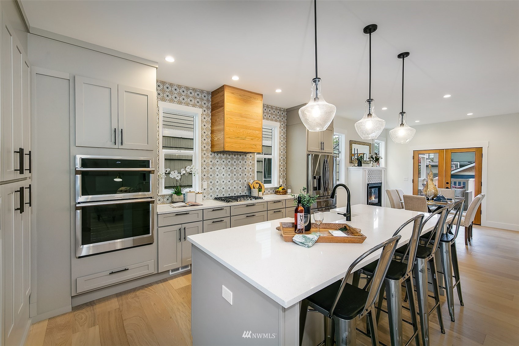 2143 6th Avenue West Seattle, WA 98119 - Photo 7 of 31 a kitchen with a dining table chairs and white cabinets