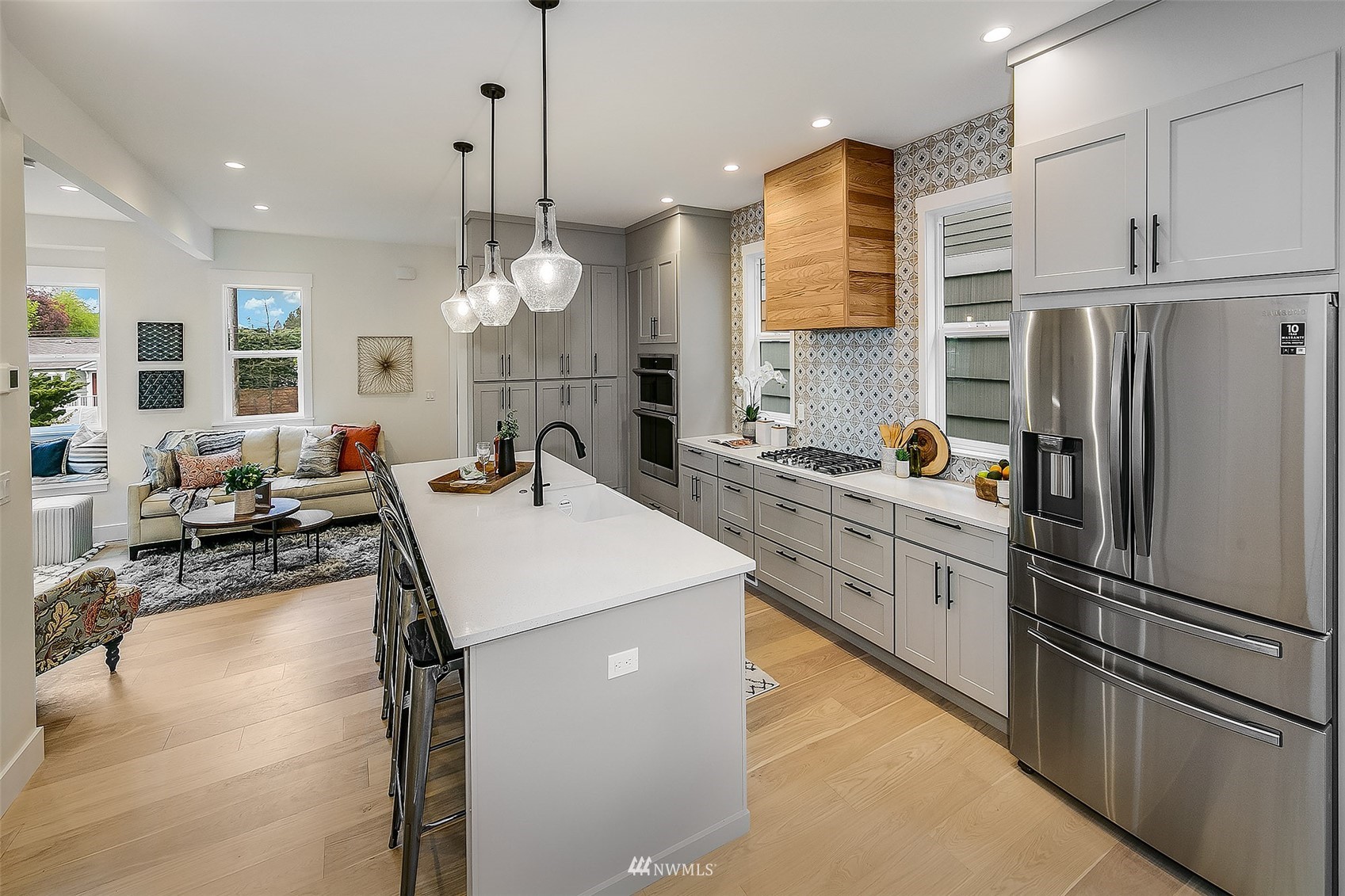 2143 6th Avenue West Seattle, WA 98119 - Photo 8 of 31 a kitchen with a refrigerator a sink dishwasher with a dining table and chairs
